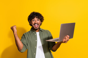 Photo of indian guy curly haired confident senior level it specialist in khaki shirt finally found a job isolated on yellow color background