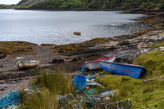 old rowboats on the shore with fishing gear crabpots in Ireland