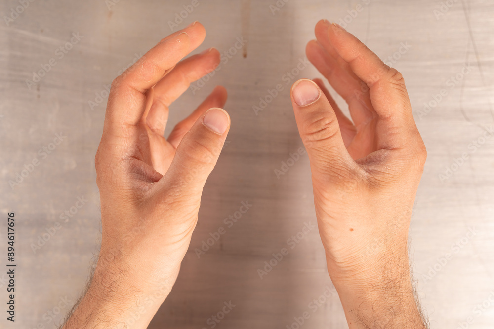 Poster two hands reach out almost touching with a soft blurred background