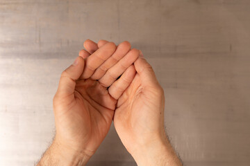 Two hands are cupped together palms facing upwards