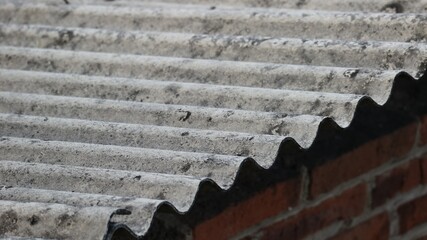 Asbestos roof tiles that have started to become ugly, originally gray in color are starting to show...