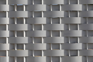 A woven pattern of grey and white slats