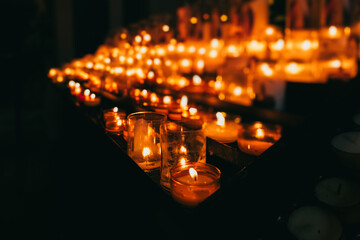 Side Angle View of Candles Burning in a Church