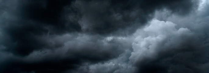Banner Dramatic dark storm clouds black sky background. Dark thunderstorm clouds rainny season. Panorama Meteorology danger windstorm disasters climate. Dark cloudscape storm cloud with copy space.