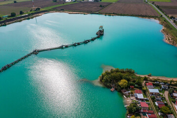 Aerial view of a quarry lake in the Hessian Ried/Germany where gravel is mined