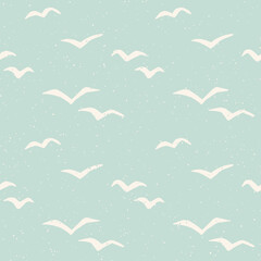 Flying seagulls pastel blue block print style seamless pattern. Bird silhouette cutouts. Vintage sea holiday background.