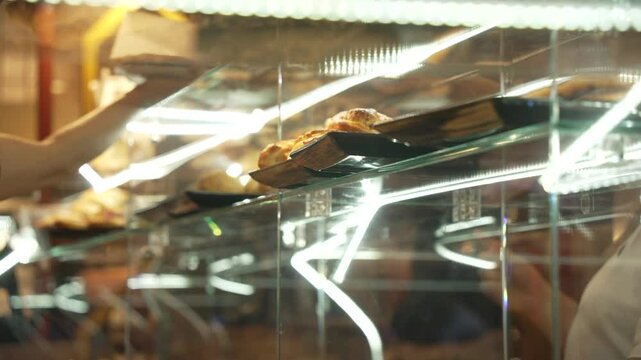 View of variety of Italian food in bakery window on bustling Via San Biagio Dei Librai, Naples, Campania, Italy