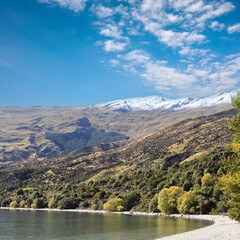 panoramic scenic view of Lake Wakatipu with mountains in the background near Queenstown, South Island, New Zealand