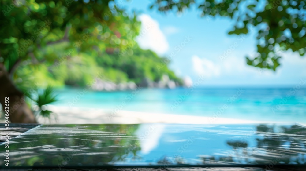 Poster a close-up of a wet, tiled deck with a blurred view of the tropical ocean and a beach behind.