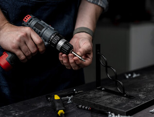 Man Holds Screwdriver In Hands Close-Up