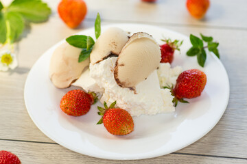 fresh organic cottage cheese with strawberries and ice cream in a plate on a wooden table