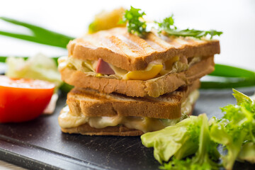 fried toasts with filling, salad leaves, tomatoes
