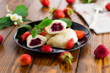 cooked sweet homemade steamed dumplings with strawberries