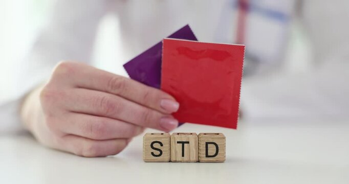 Word STD from wooden cubes against doctor at workplace