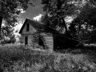 Black and white photo of an abandoned farmhouse in rural North Dakota