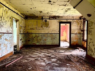 Interior of a damaged living room within an abandoned farmhouse in rural North Dakota