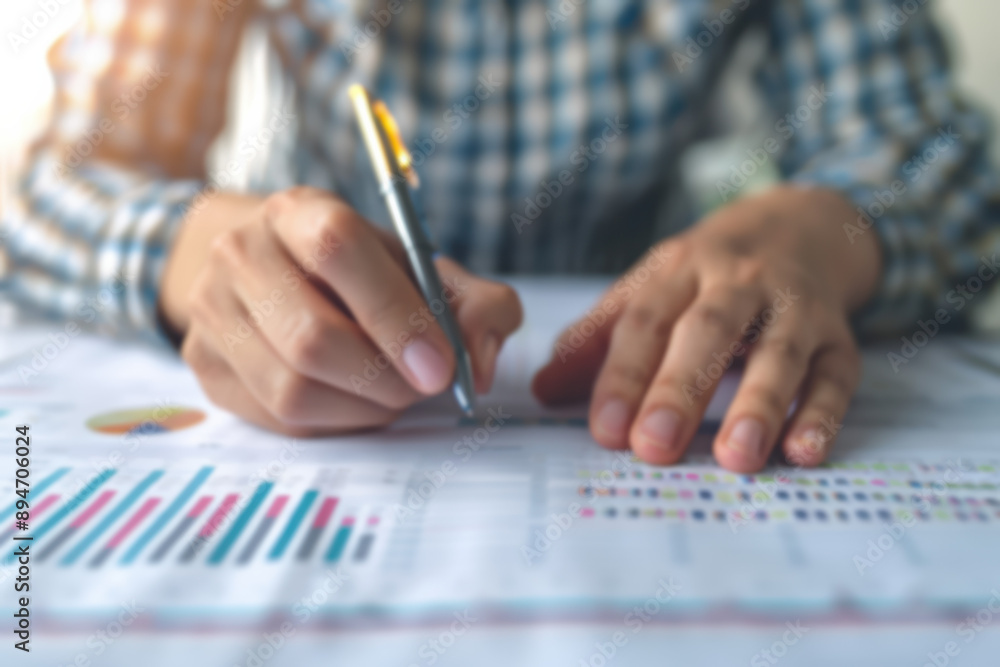 Poster close-up of a person analyzing financial charts and graphs on a document, highlighting financial pla