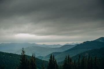 Mountain spring landscape. Overcast weather. The sky is overcast with dark clouds. Beautiful...
