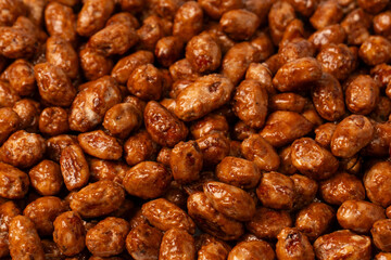 Tasty sweet roasted peanuts as a background.