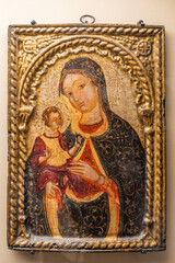 Iconic medieval painting portraiting Virgin Mary in blue holding Jesus as a boy