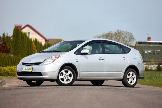 Berlin, Germany - May, 3 2024: Toyota Prius XW20 2009 hybrid electric car over out of focus rural background, three quarter front view