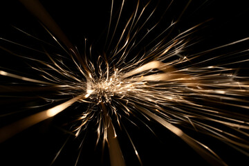 sparks from the grinder glowing in the dark