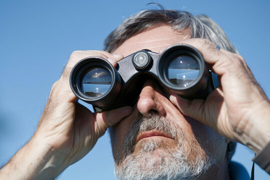 Man using binoculars to observe nature