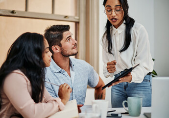 Obraz premium Woman, team and tablet in office for coaching, workshop and questions in meeting for development at startup. Business people, group and training with app, progress and diversity at creative agency