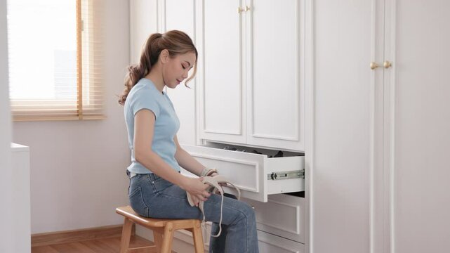 Young adult woman asia people arrange stack undies manage used old bra neat basket box clean house closet shelf eco care. Happy asian smile go green wife home chores zero waste reduce fabric issue
