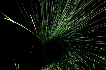 green sparks from the grinder glowing in the dark