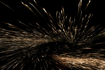 sparks from the grinder glowing in the dark