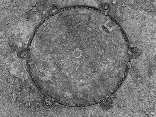 Manhole grunge style background, ground close view photo. Pencil drawn sketch