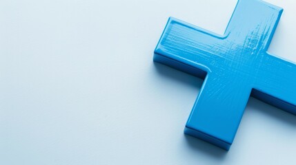 Obraz premium Close-Up of Blue Plus Sign on Light Blue Background