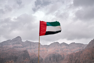 UAE flag waving in the mountains