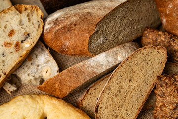 Assorted bread on a wooden table with sourdough in glass cups.