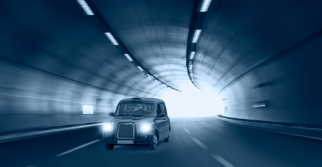 Highway road tunnel with Typical black british taxi cab