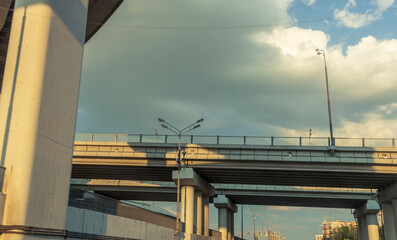 A bridge with a cloudy sky in the background