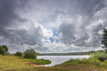 A cloudy sky with a lake in the background