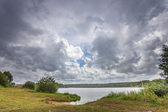 A cloudy sky with a lake in the background
