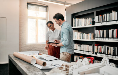 Man, woman and tablet for architecture in office for review, design or blueprint for property expansion. People, reading and notes for floor plan, feedback or quality assurance at construction agency