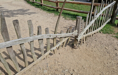 fencing of the pasture from rough-hewn logs. the connection to the post is made using a rope. the...