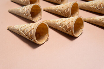 Waffle cones arranged on beige background