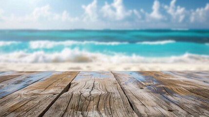 Fototapeta premium A close-up of weathered wooden planks with a blurry background of a sunny beach with turquoise water and white clouds.