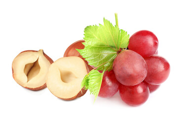 Hazelnuts and pink grapes isolated on white
