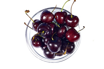 a bowl of red cherry isolated on a white background. Top view