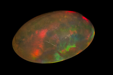natural rainbow opal gem isolated on black background