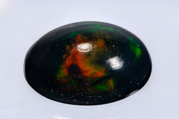 natural rainbow opal gem isolated on black background