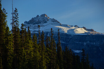 Canadian Rockies with a glacier high on the mountain.