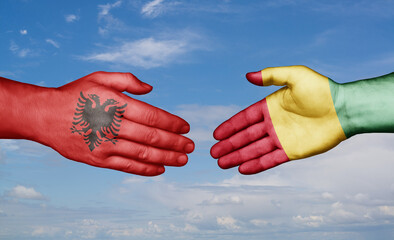 Republic of Guinea and Albania country handshaking with flags, consensus concept international co-operation illustration