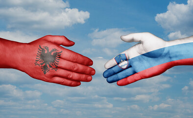 Slovenia and Albania country handshaking with flags, consensus concept international co-operation illustration